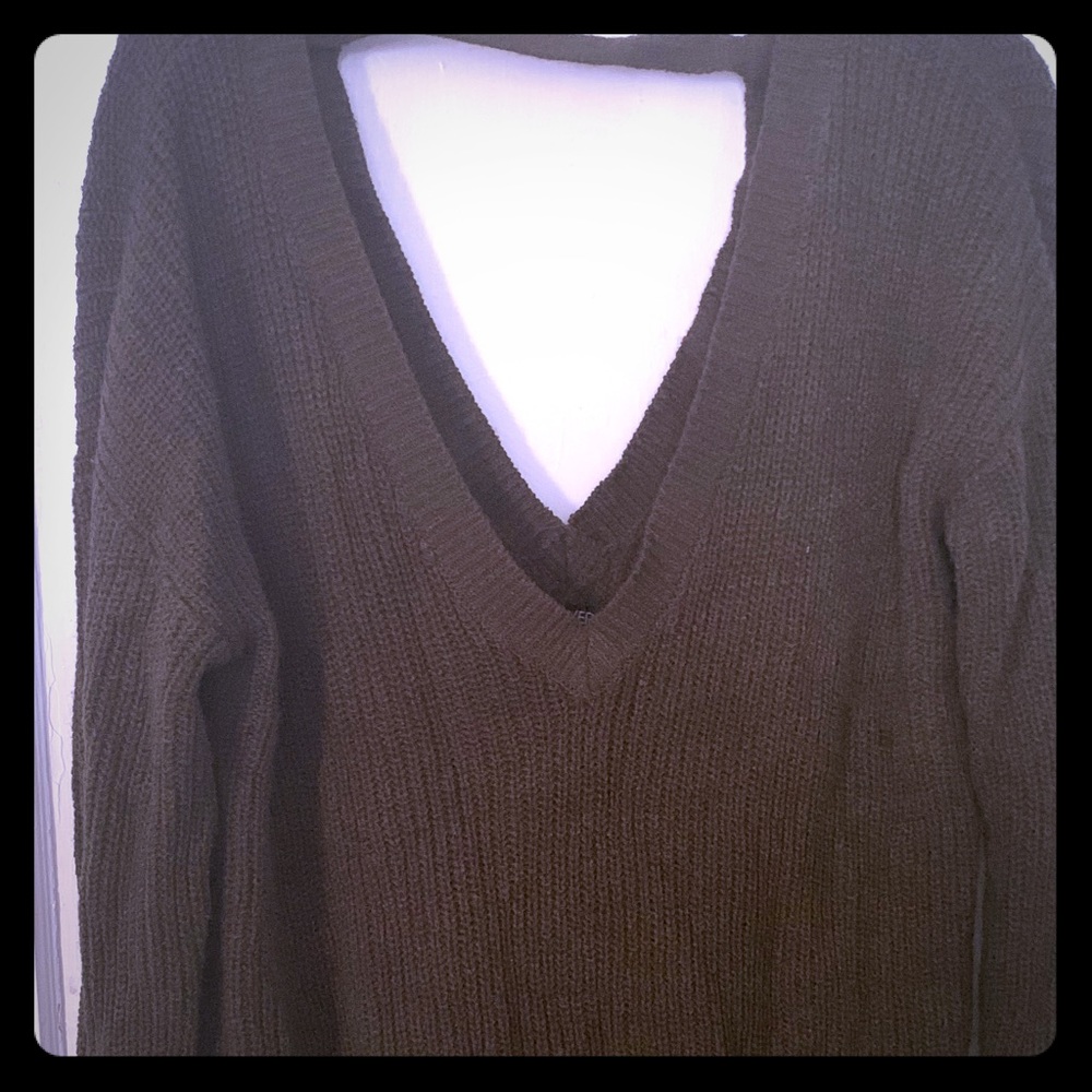 Green v-neck sweater.